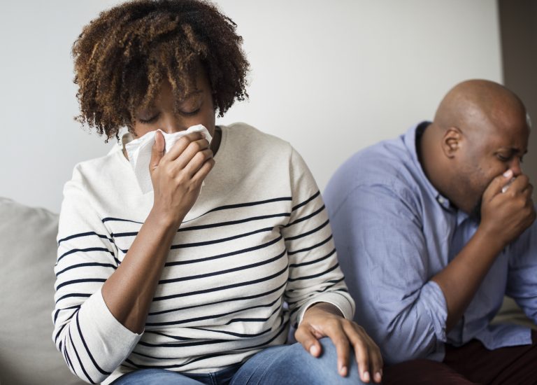 Woman sick and sneezing